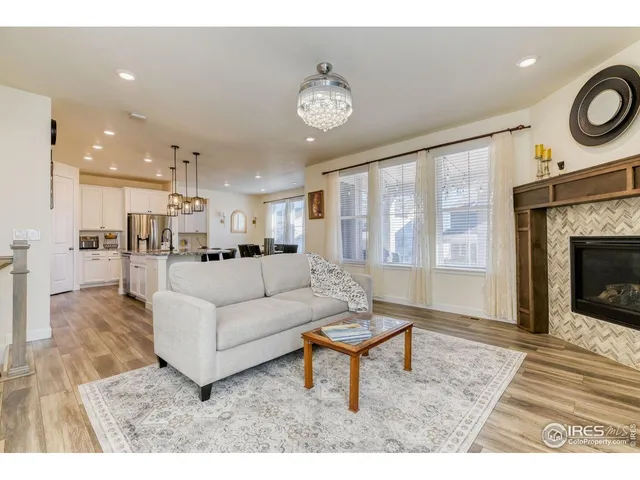 a living room with furniture a fireplace and a table