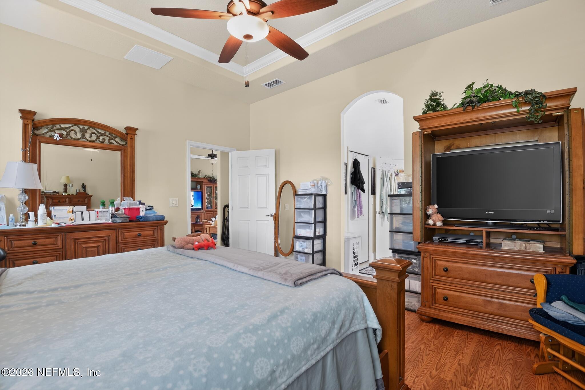 110 Vía Roma Ormond Beach, FL 32174 - Photo 22 of 43 a bedroom with bed and a flat tv screen on dresser