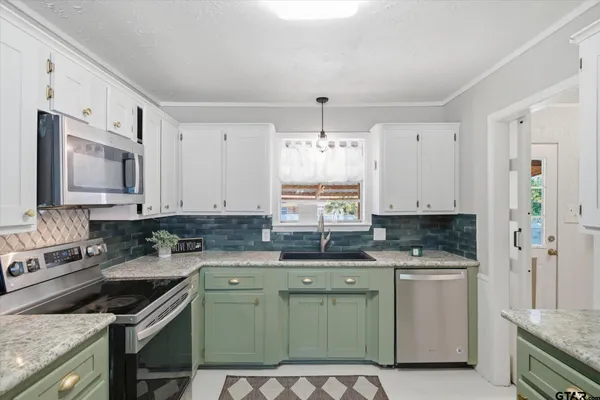 a kitchen with a sink stove top oven and cabinets