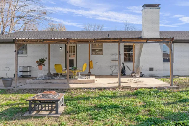 a view of a house with a yard patio and swimming pool