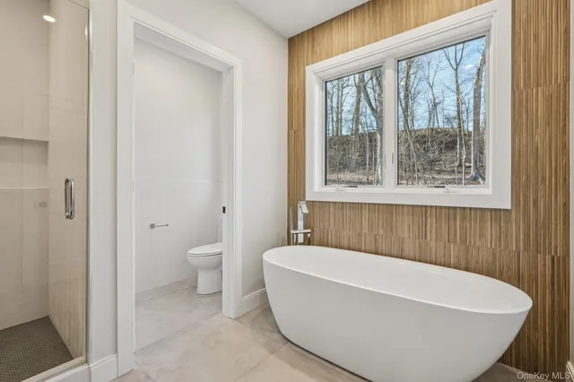 a white bath tub sitting next to a toilet