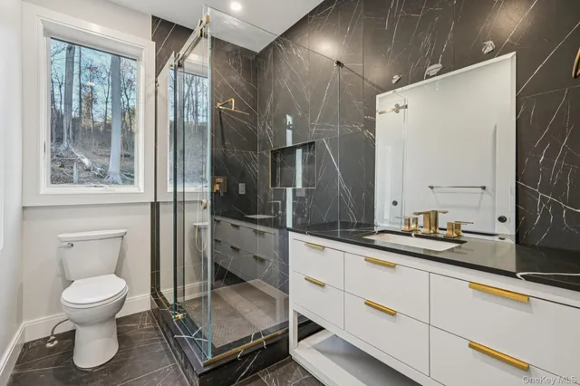 a bathroom with a toilet sink and a mirror