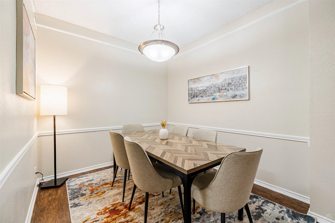 11908 Anderson Mill Road, Unit 732 Austin, TX 78726 - Photo 13 of 23 a view of a dining room with furniture and wooden floor