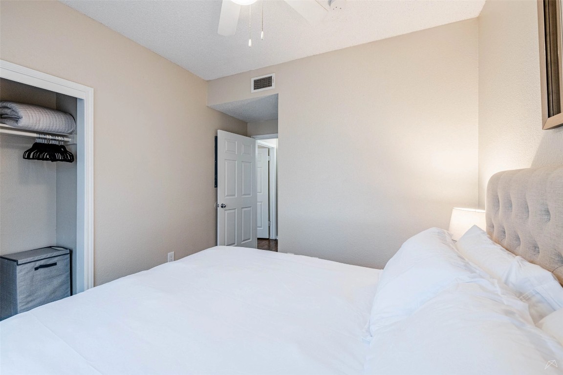 11908 Anderson Mill Road, Unit 732 Austin, TX 78726 - Photo 16 of 23 a bedroom with a bed and a night stand