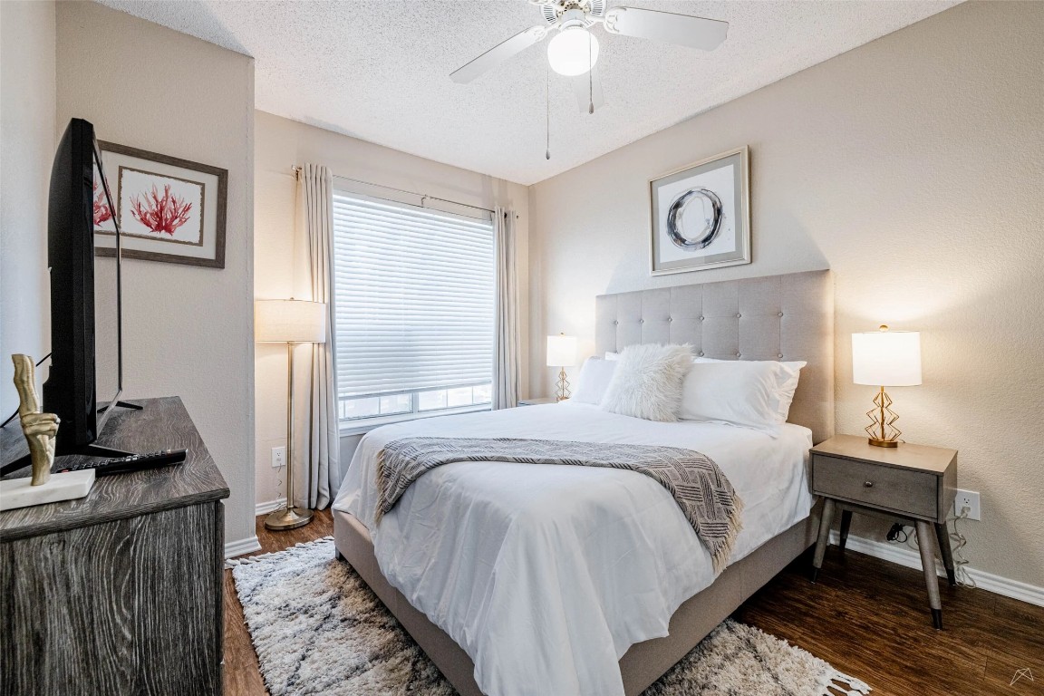 11908 Anderson Mill Road, Unit 732 Austin, TX 78726 - Photo 18 of 23 a bedroom with bed and a chandelier