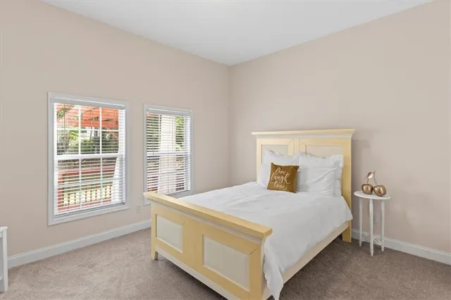 a bedroom with a bed and window