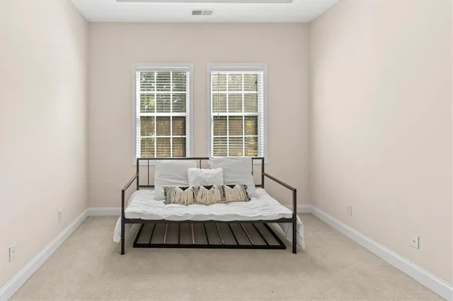 a bedroom with bed and a window