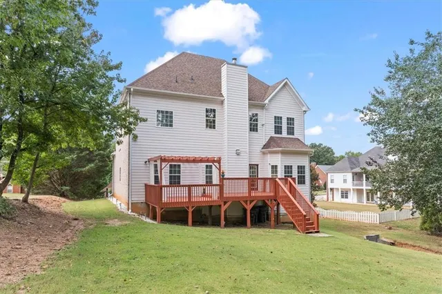a view of a house with a yard and sitting area