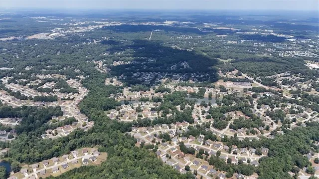 an aerial view of house with yard and mountain view in back