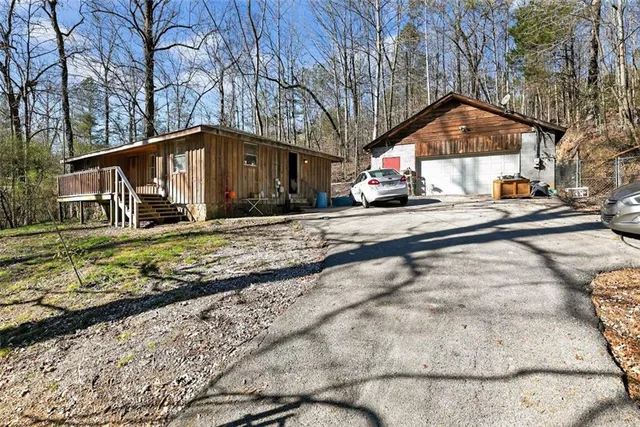 a view of a house with a yard covered in snow
