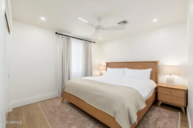 a bedroom with a bed and a night stand