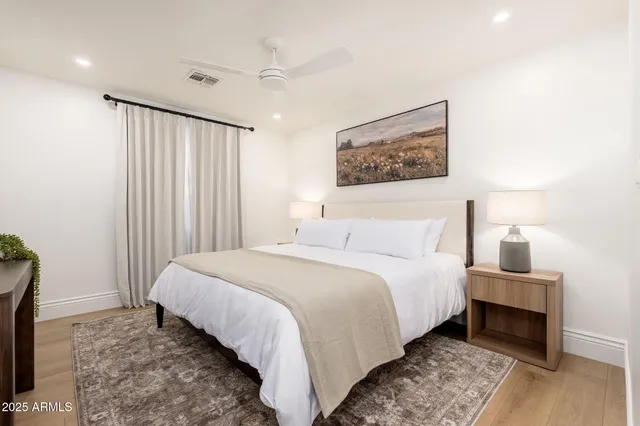 a bedroom with a bed and a night stand