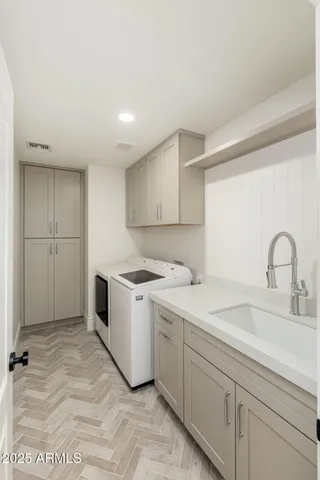 a kitchen with a sink cabinets and appliances