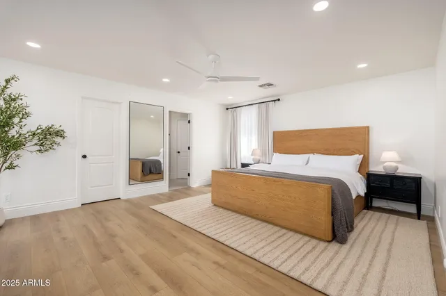 a bedroom with a bed and a potted plant