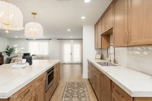 a kitchen with a sink dishwasher a stove and a microwave oven with cabinets
