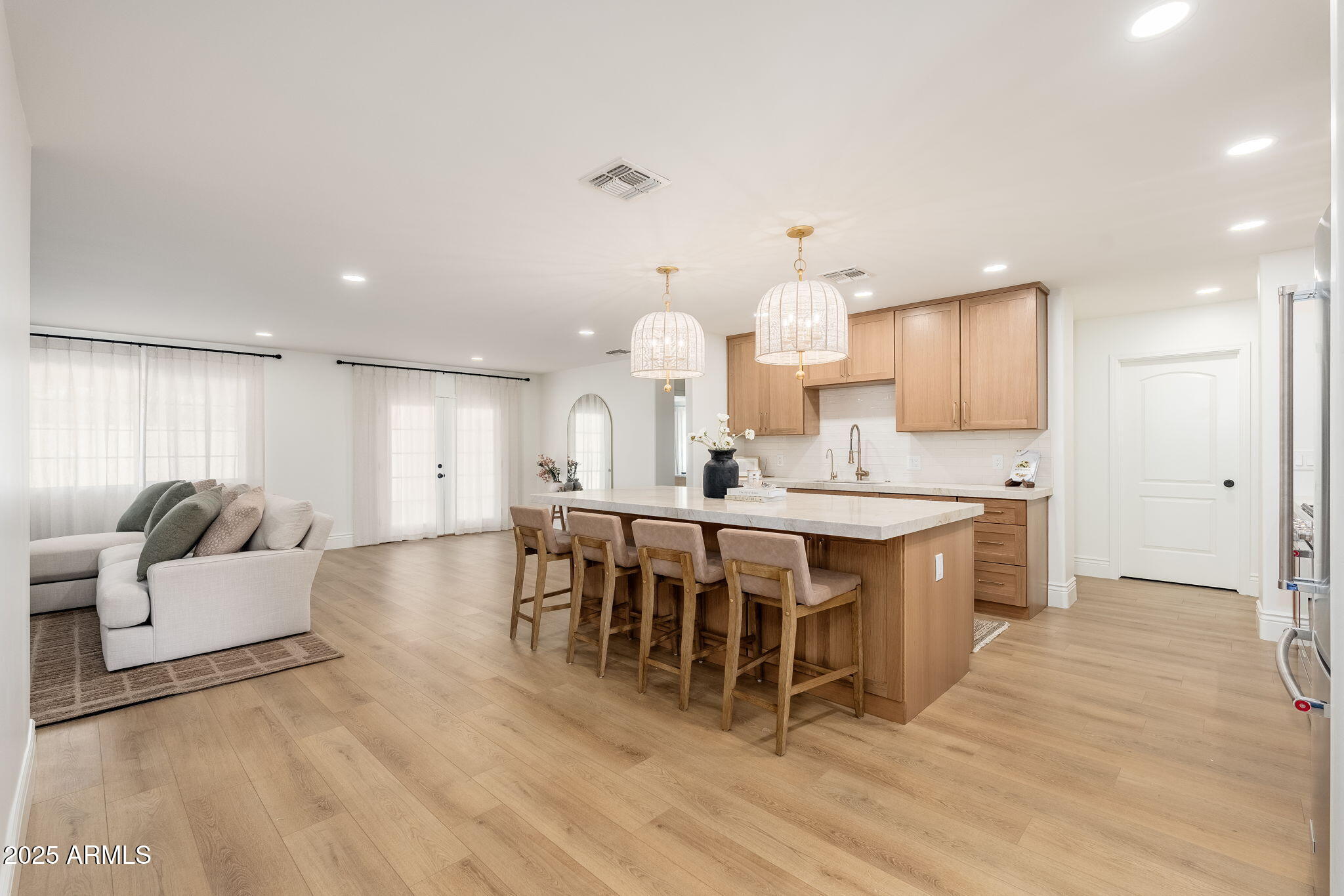 4030 East Fairmount Avenue Phoenix, AZ 85018 - Photo 4 of 23 a large kitchen with kitchen island a sink table and chairs