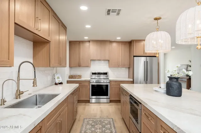 a kitchen with a sink stainless steel appliances and cabinets