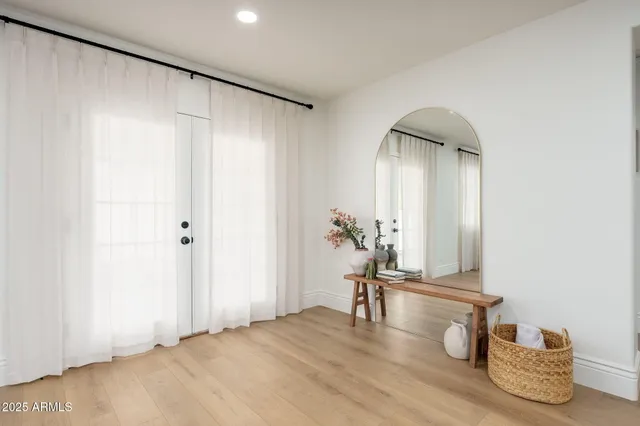 a view of empty room with wooden floor