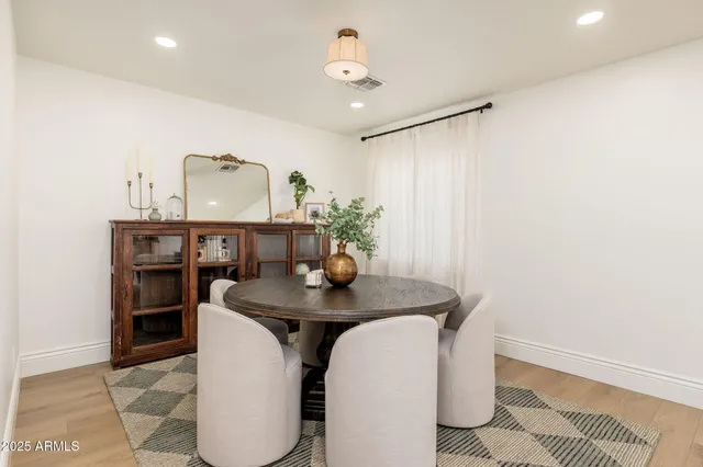 a dining room with furniture and window