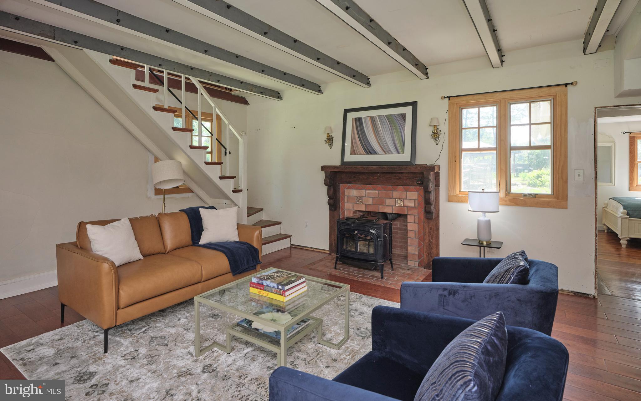 2598 River Road New Hope, PA 18938 - Photo 12 of 28 a living room with furniture a fireplace and a large window