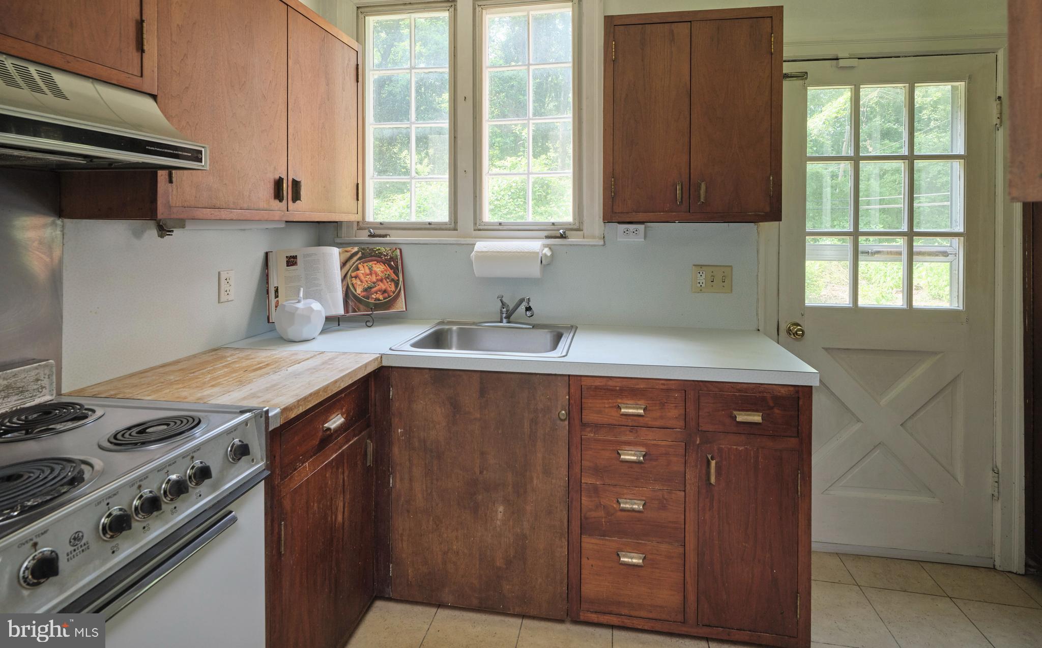 2598 River Road New Hope, PA 18938 - Photo 16 of 28 a kitchen with a sink a stove and cabinets