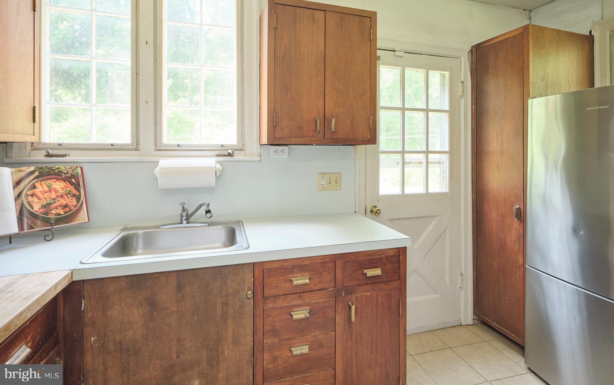 2598 River Road New Hope, PA 18938 - Photo 18 of 28 a kitchen with stainless steel appliances granite countertop a sink a refrigerator and a window