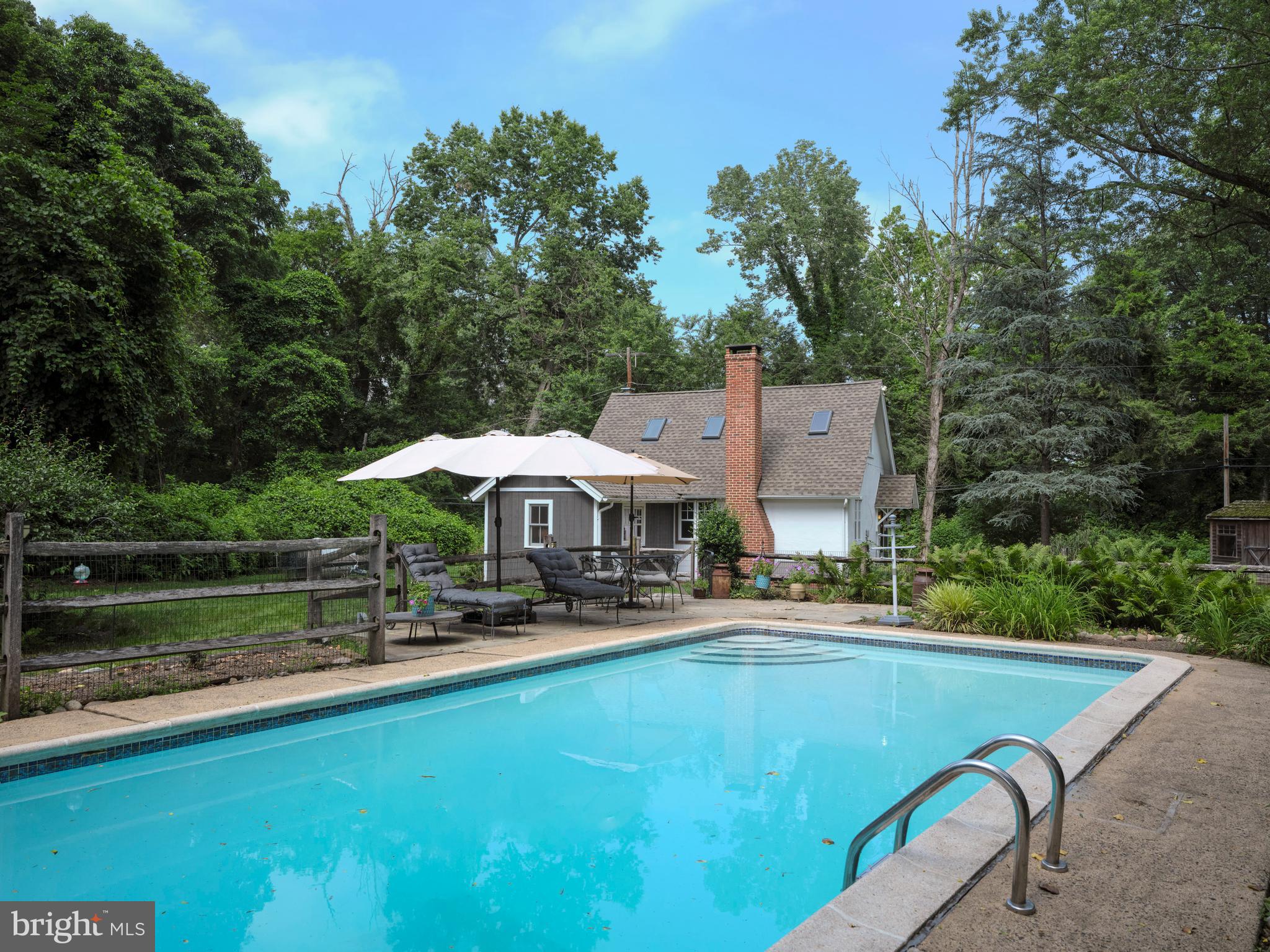 2598 River Road New Hope, PA 18938 - Photo 5 of 28 swimming pool view with a seating space and a garden view