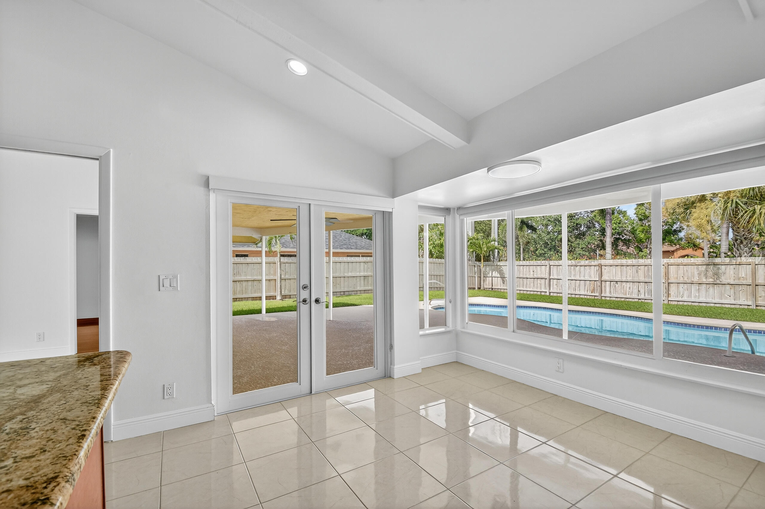 1877 Shower Tree Way Wellington, FL 33414 - Photo 19 of 53 wooden floor to ceiling window and an empty room