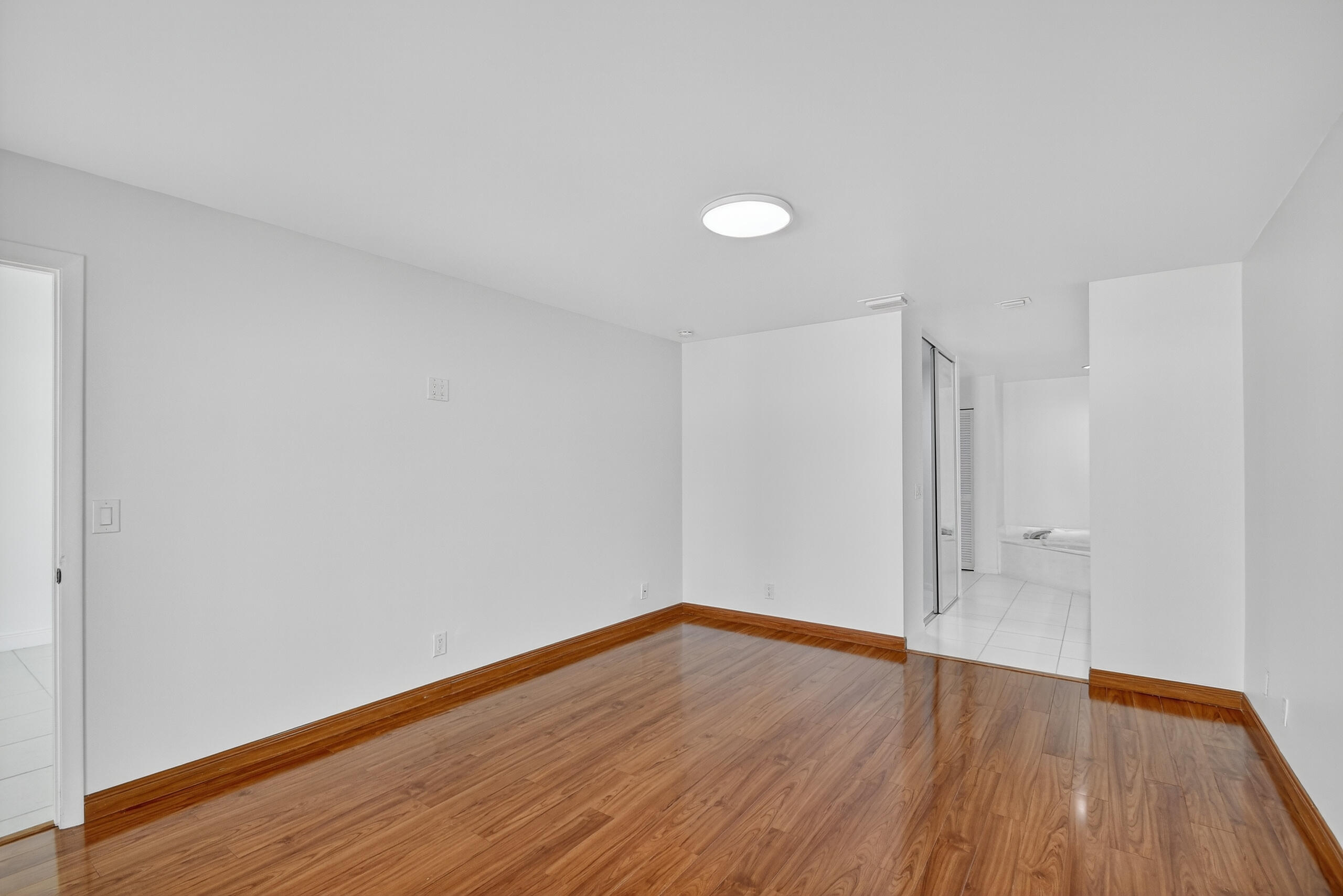 1877 Shower Tree Way Wellington, FL 33414 - Photo 25 of 53 a view of an empty room with wooden floor