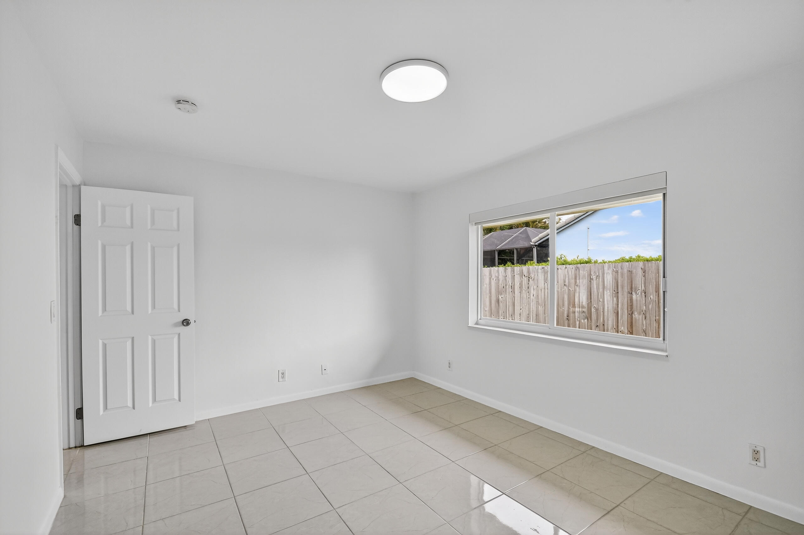 1877 Shower Tree Way Wellington, FL 33414 - Photo 35 of 53 a view of an empty room with a window and closet area