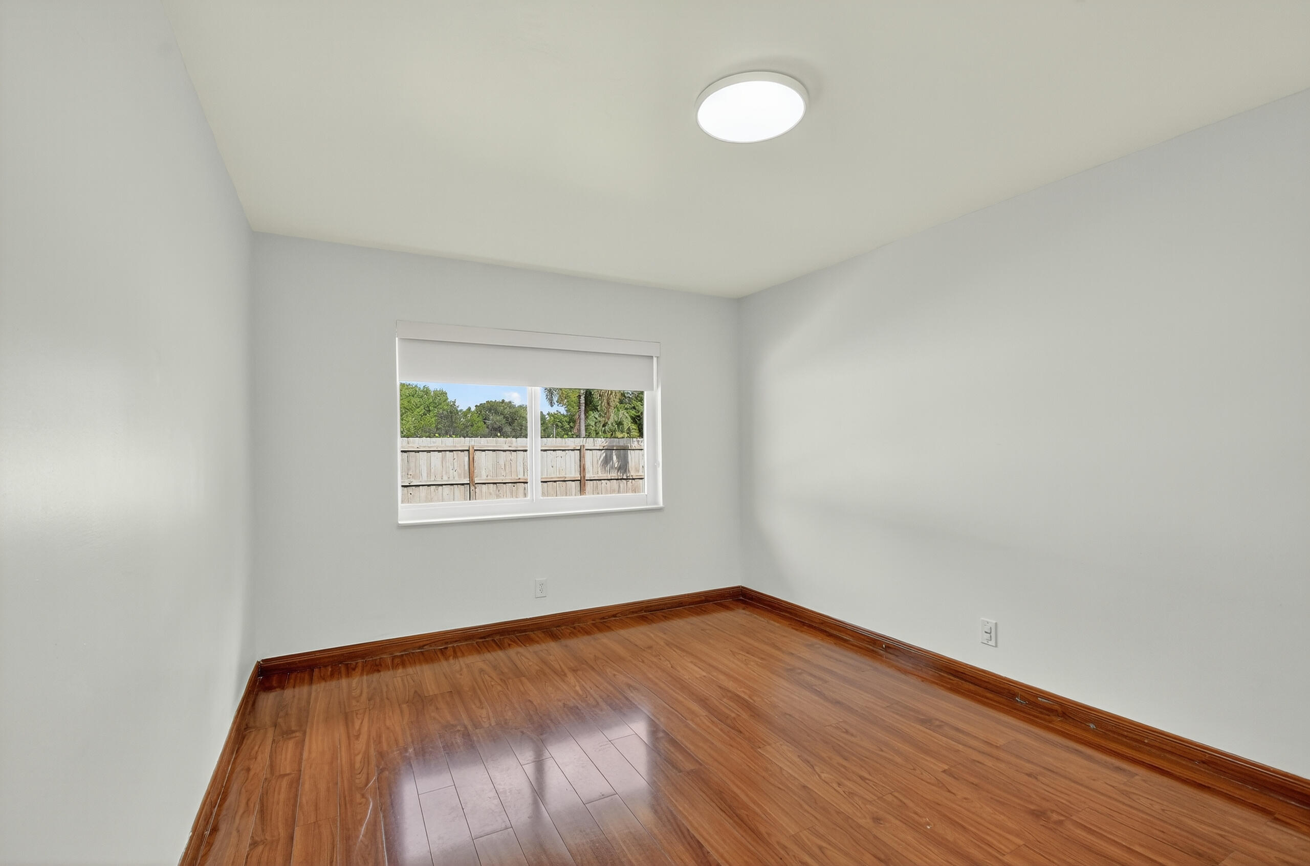 1877 Shower Tree Way Wellington, FL 33414 - Photo 36 of 53 an empty room with wooden floor and windows