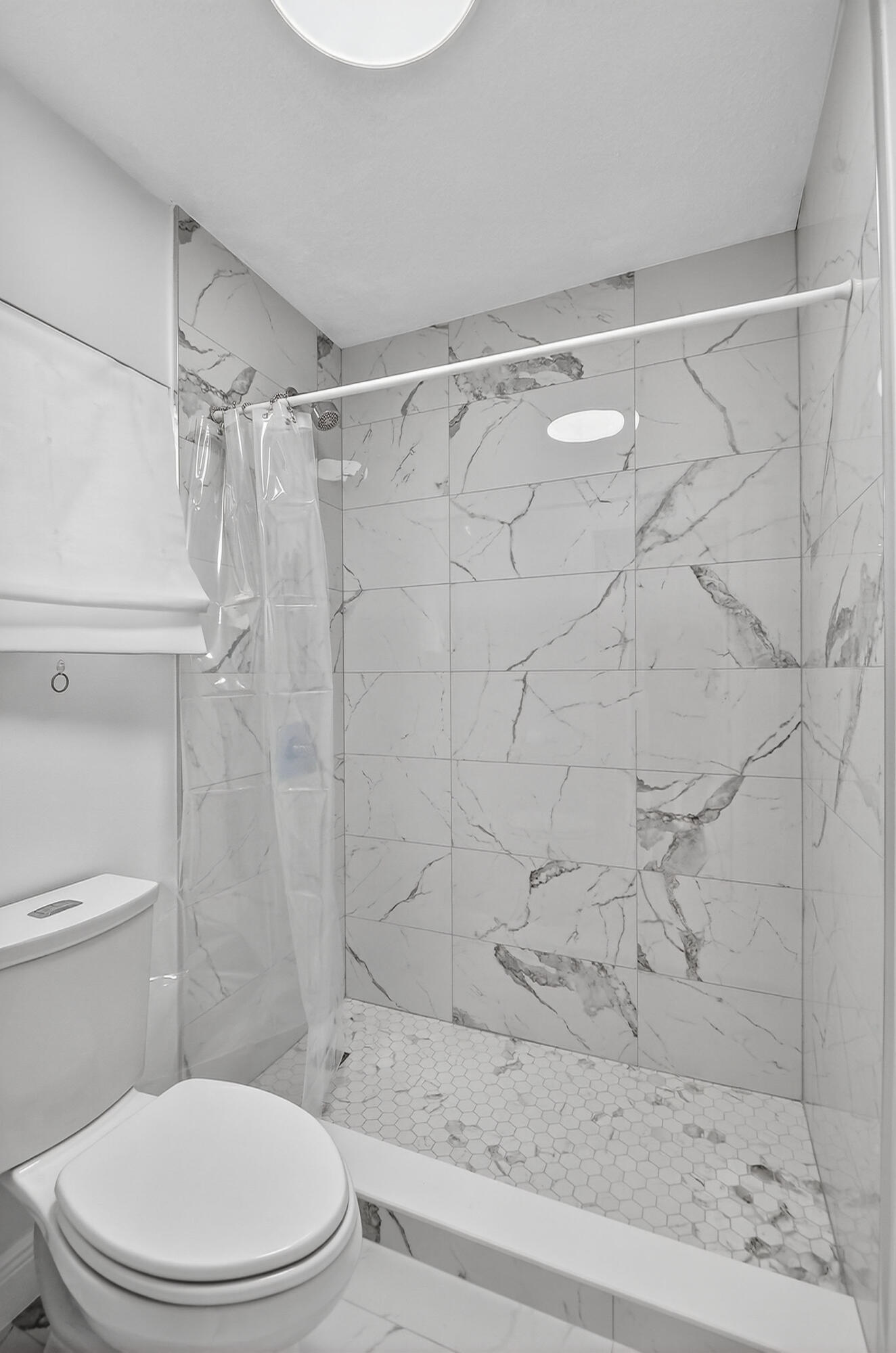 1877 Shower Tree Way Wellington, FL 33414 - Photo 40 of 53 a white toilet sitting next to a bath tub and a shower