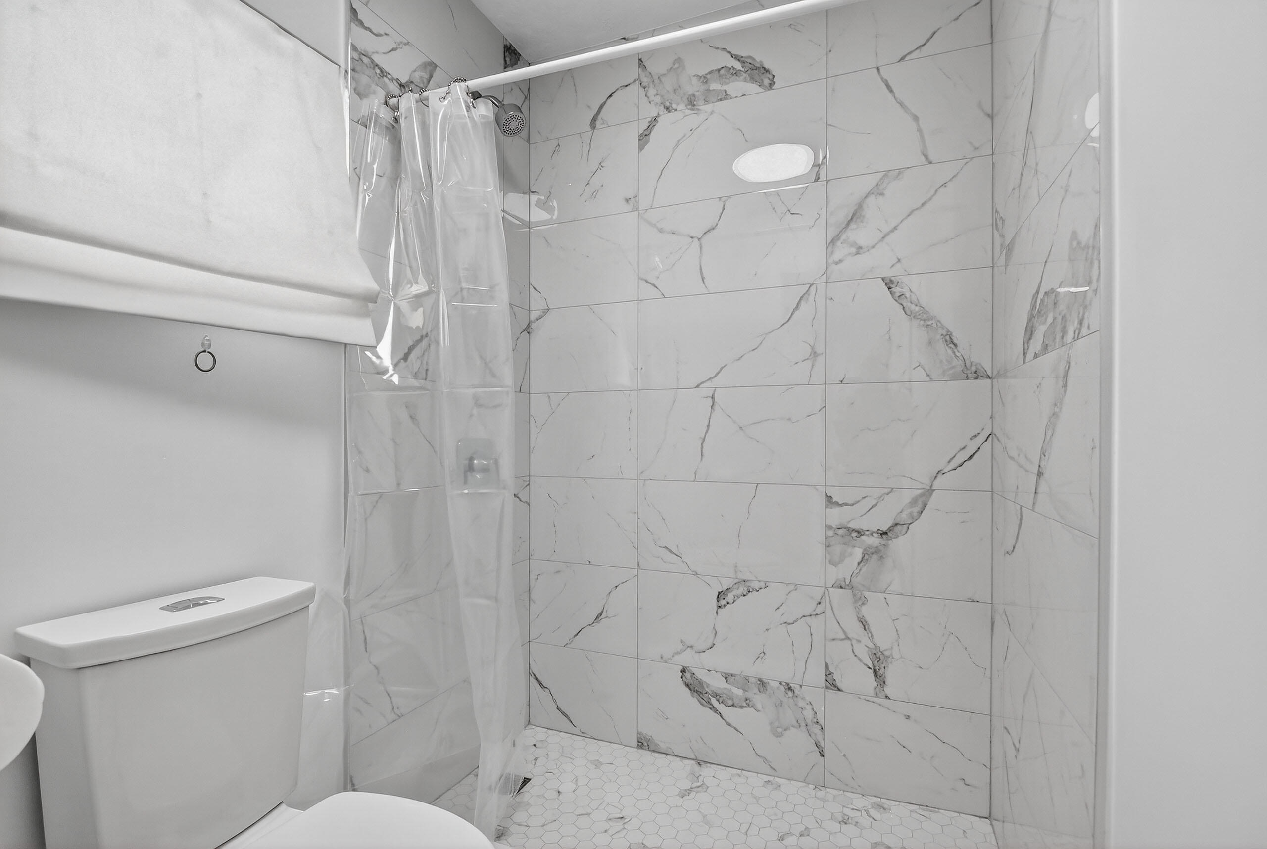 1877 Shower Tree Way Wellington, FL 33414 - Photo 41 of 53 a bathroom with a shower and toilet