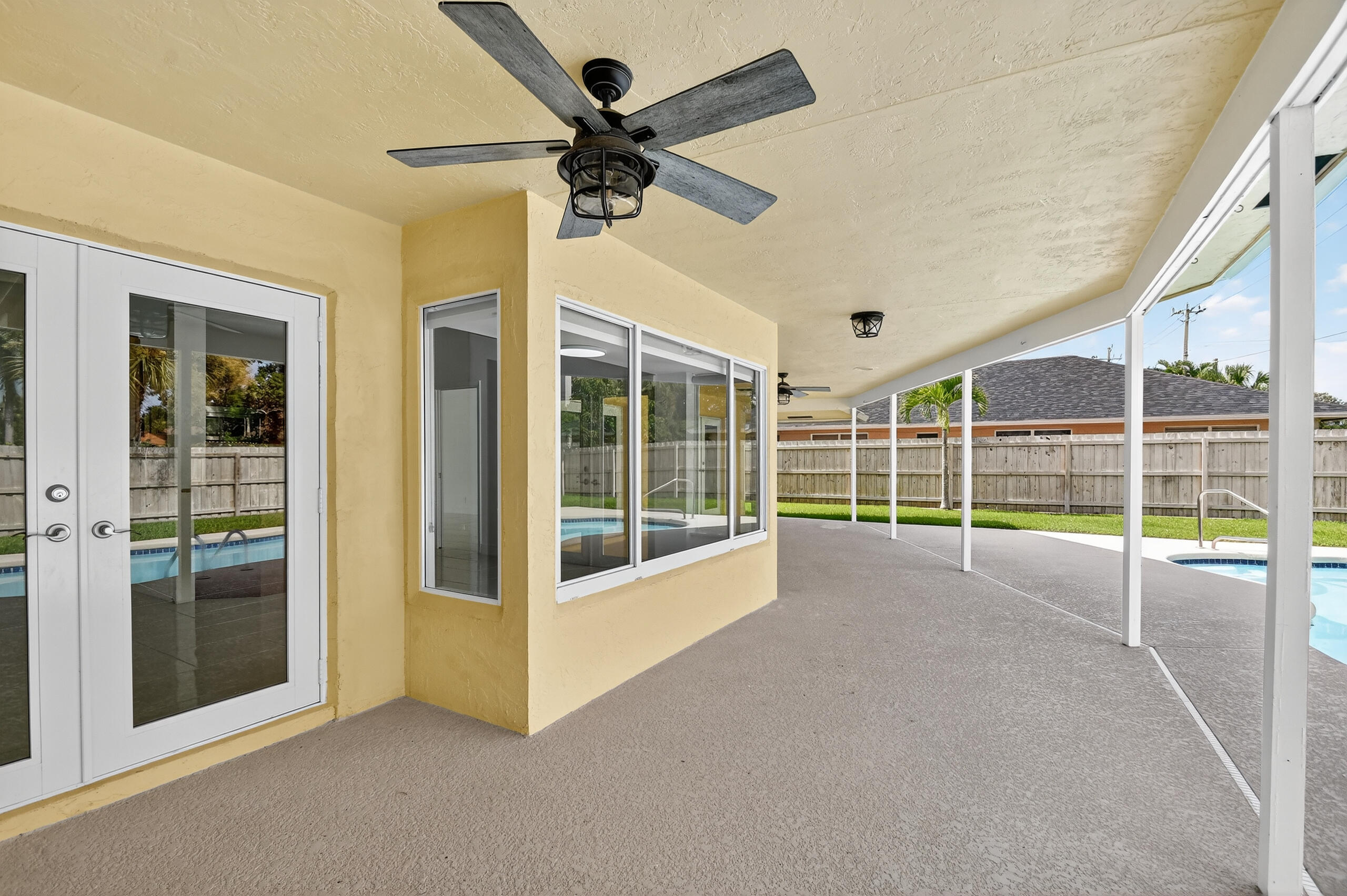 1877 Shower Tree Way Wellington, FL 33414 - Photo 45 of 53 a view of a livingroom with a ceiling fan and window