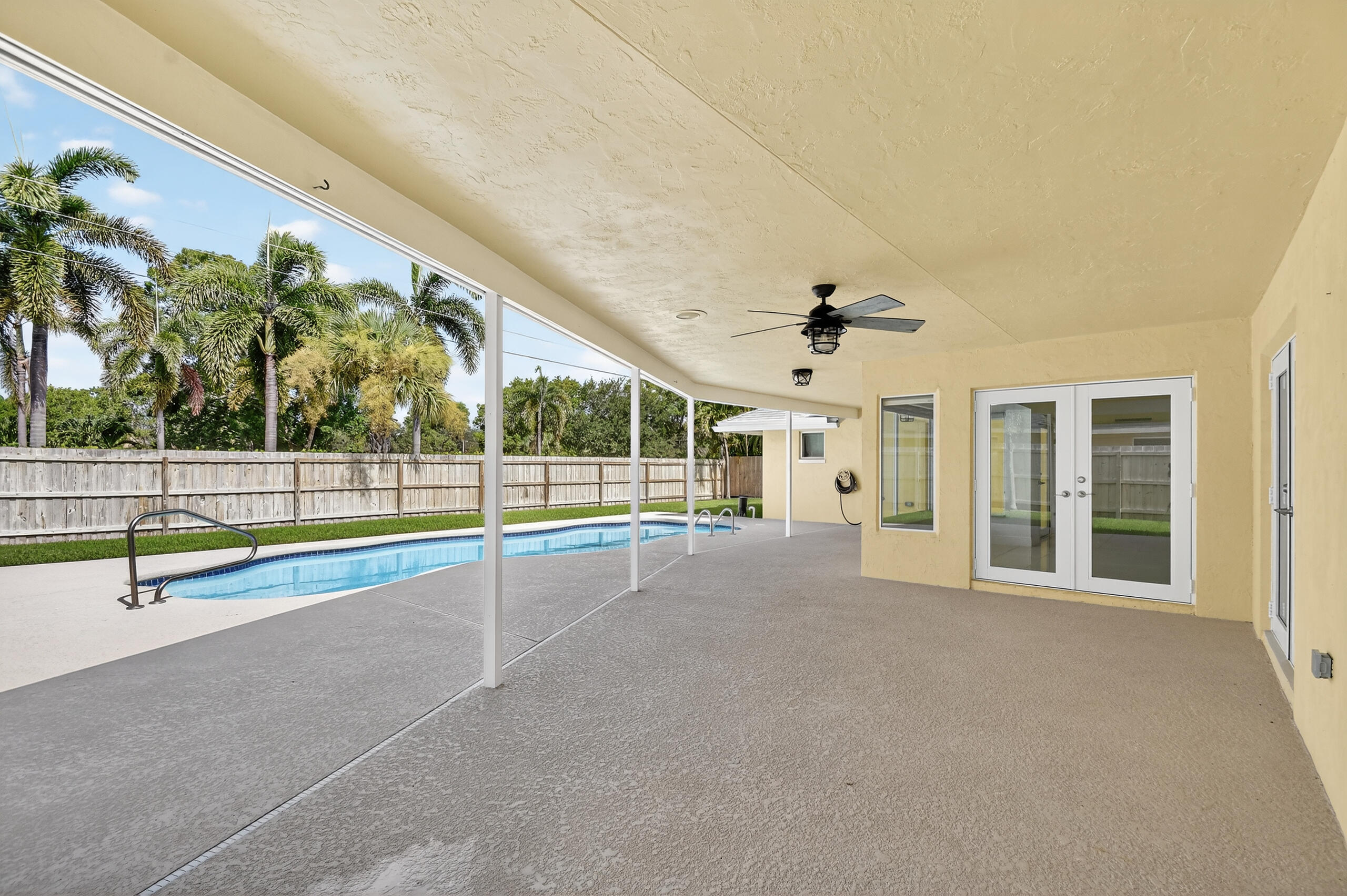 1877 Shower Tree Way Wellington, FL 33414 - Photo 48 of 53 a view of an swimming pool with a porch