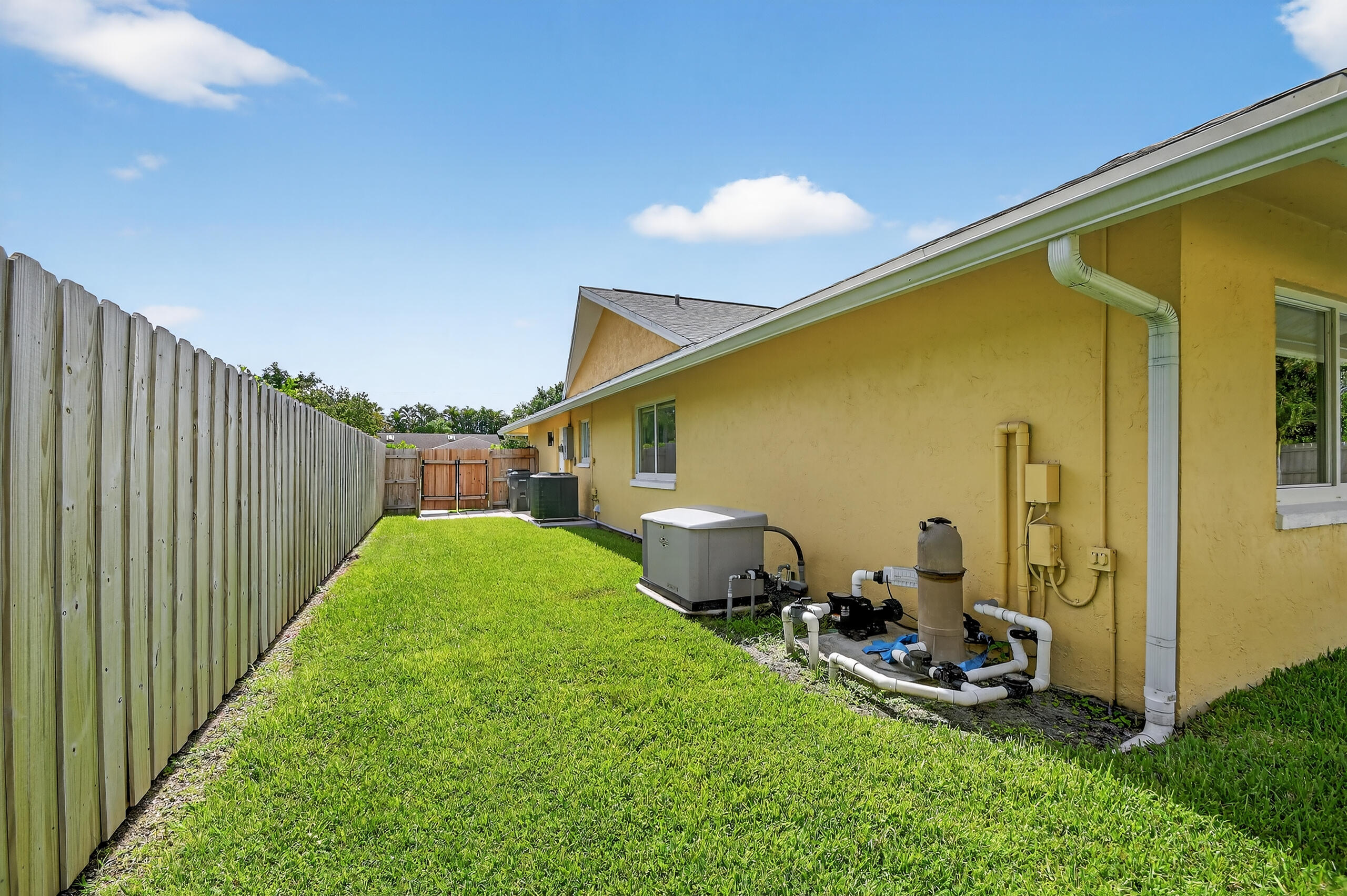 1877 Shower Tree Way Wellington, FL 33414 - Photo 53 of 53 a view of a backyard with plants and a patio