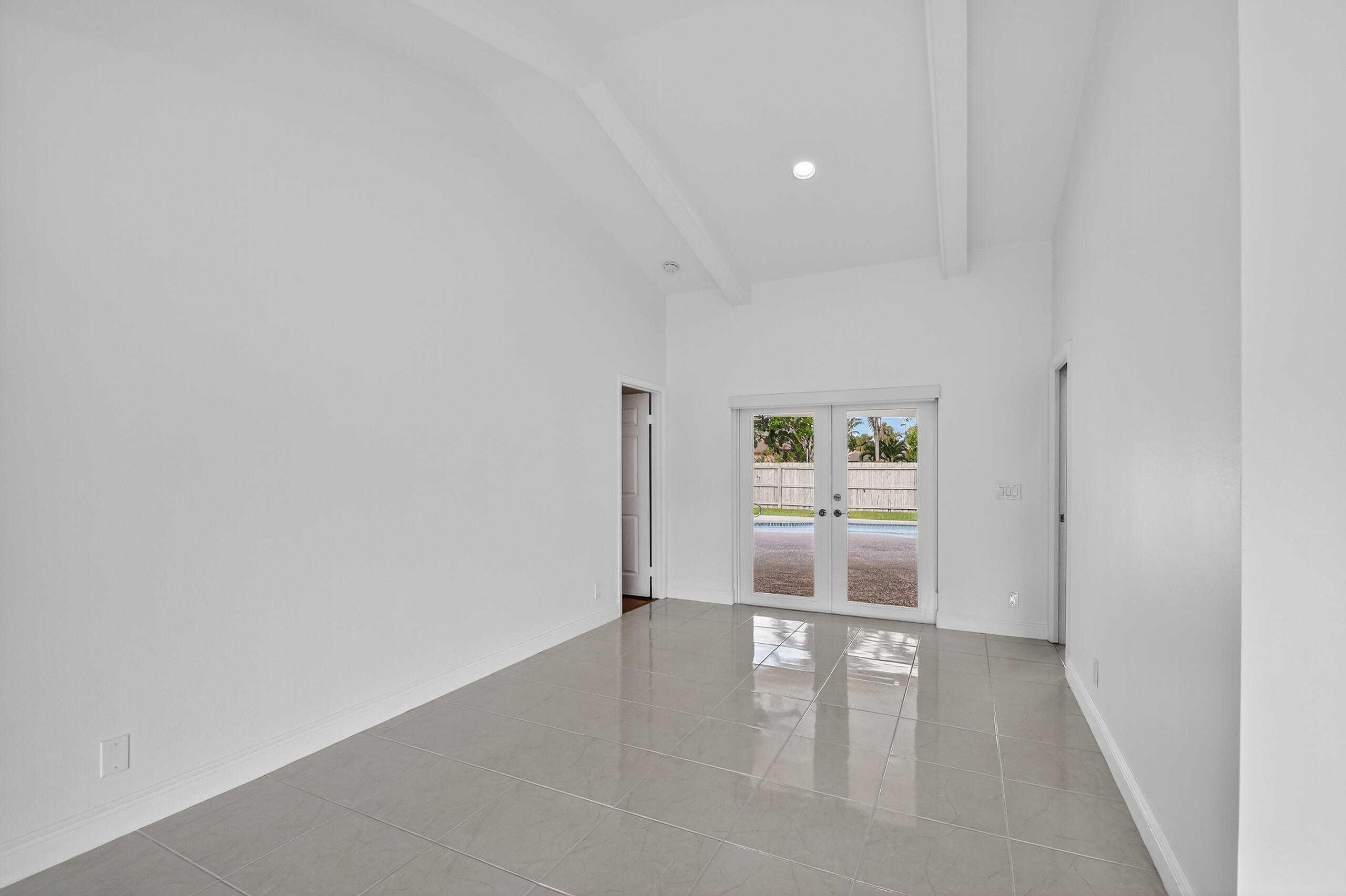1877 Shower Tree Way Wellington, FL 33414 - Photo 10 of 53 an empty room with windows and cabinet