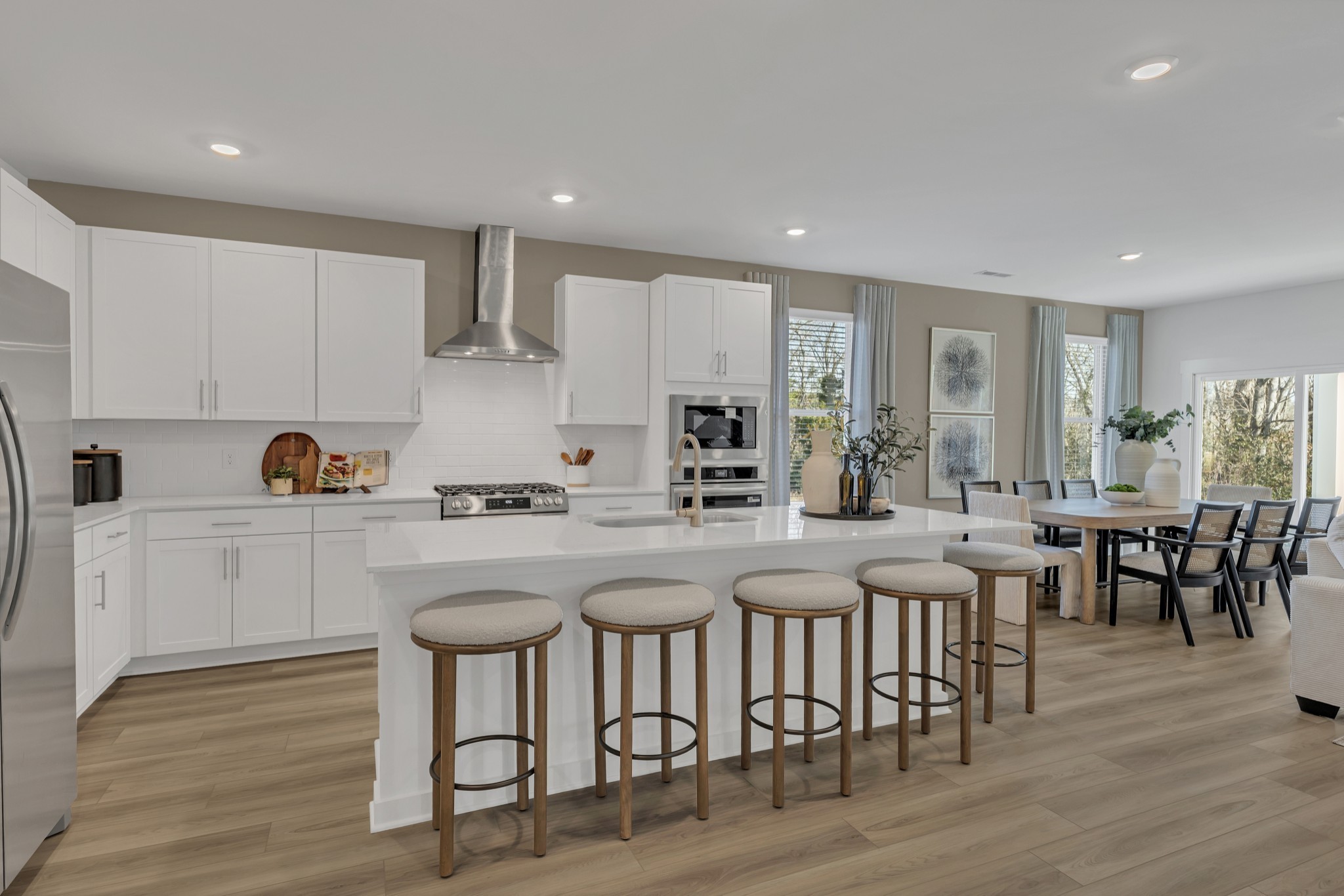 6356 North New Hope Road Hermitage, TN 37076 - Photo 6 of 37 a kitchen with stainless steel appliances granite countertop a dining table chairs stove refrigerator and cabinets