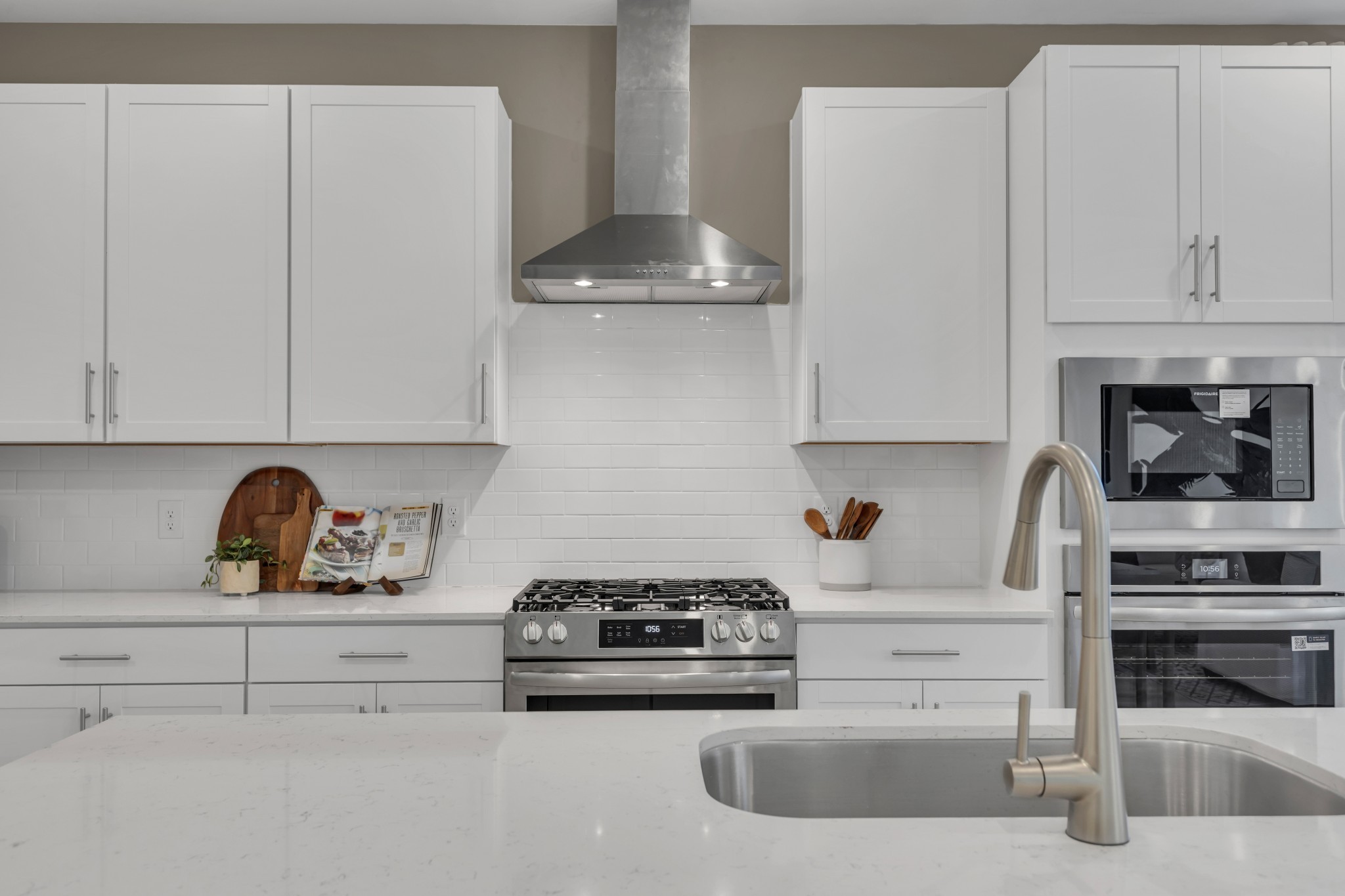 6356 North New Hope Road Hermitage, TN 37076 - Photo 7 of 37 a kitchen with white cabinets and appliances