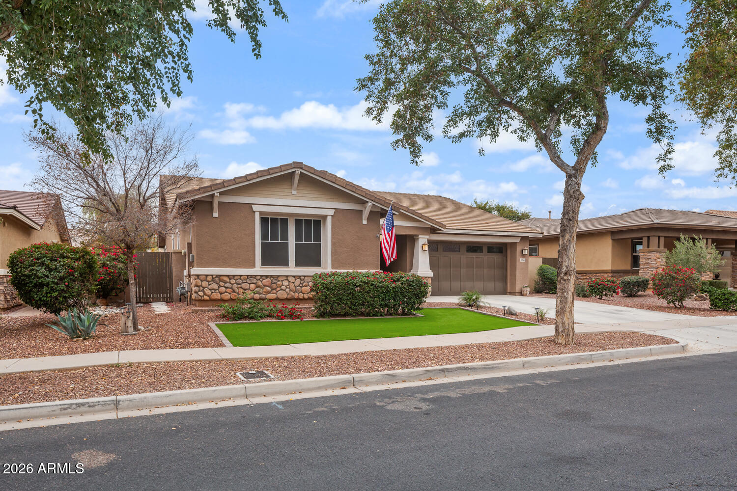 3246 North Springfield Street Buckeye, AZ 85396 - Photo 1 of 27 a front view of a house with a yard and garage