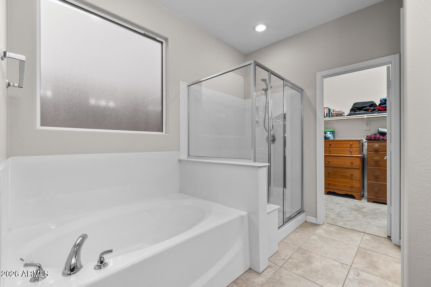3246 North Springfield Street Buckeye, AZ 85396 - Photo 11 of 27 a bathroom with a tub and shower