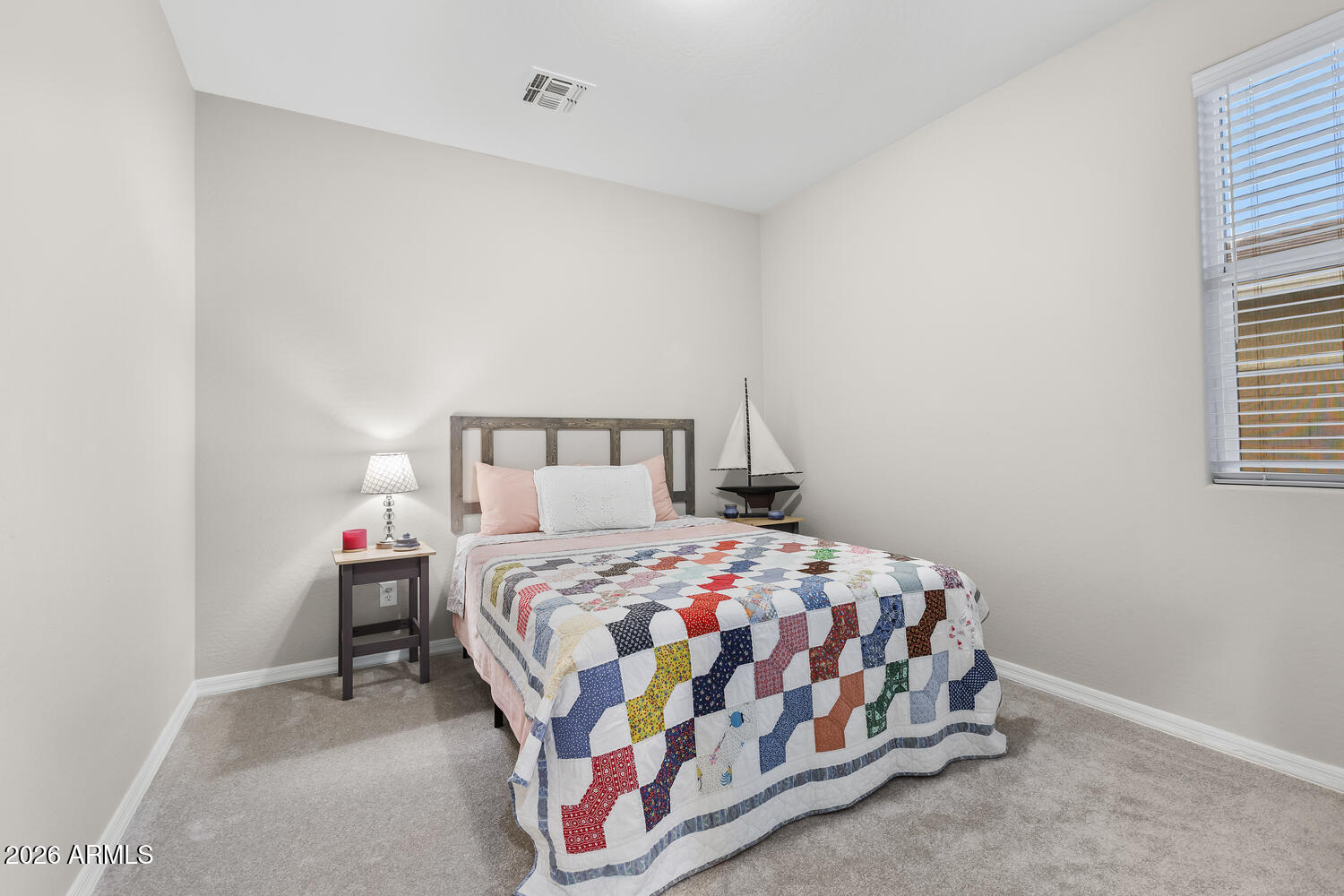 3246 North Springfield Street Buckeye, AZ 85396 - Photo 13 of 27 a bedroom with a bed and window