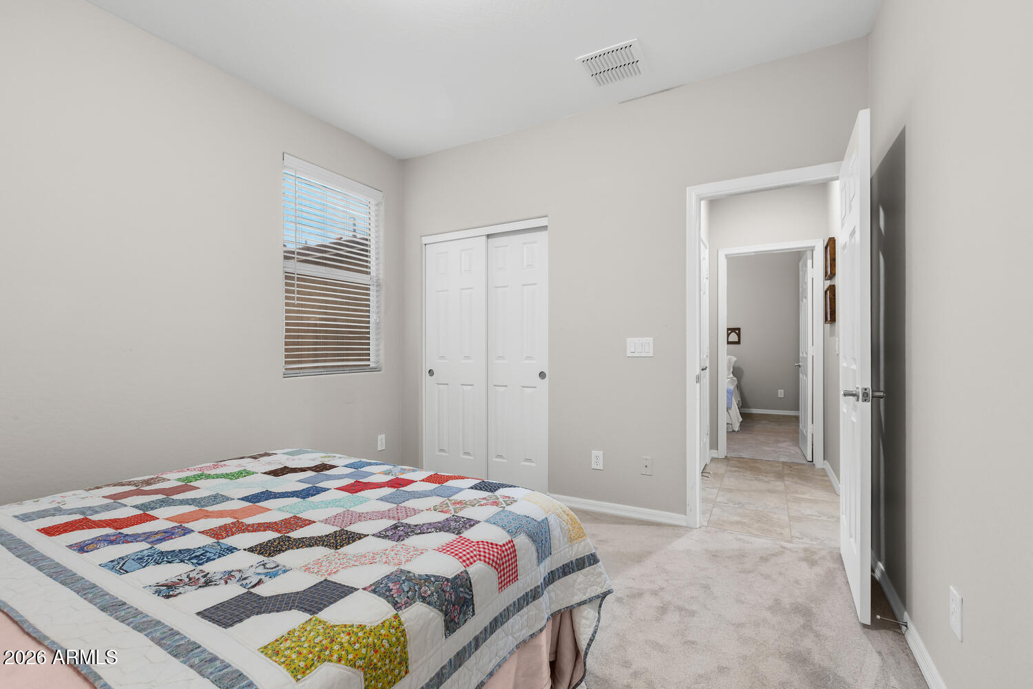 3246 North Springfield Street Buckeye, AZ 85396 - Photo 14 of 27 a bedroom with bed and window