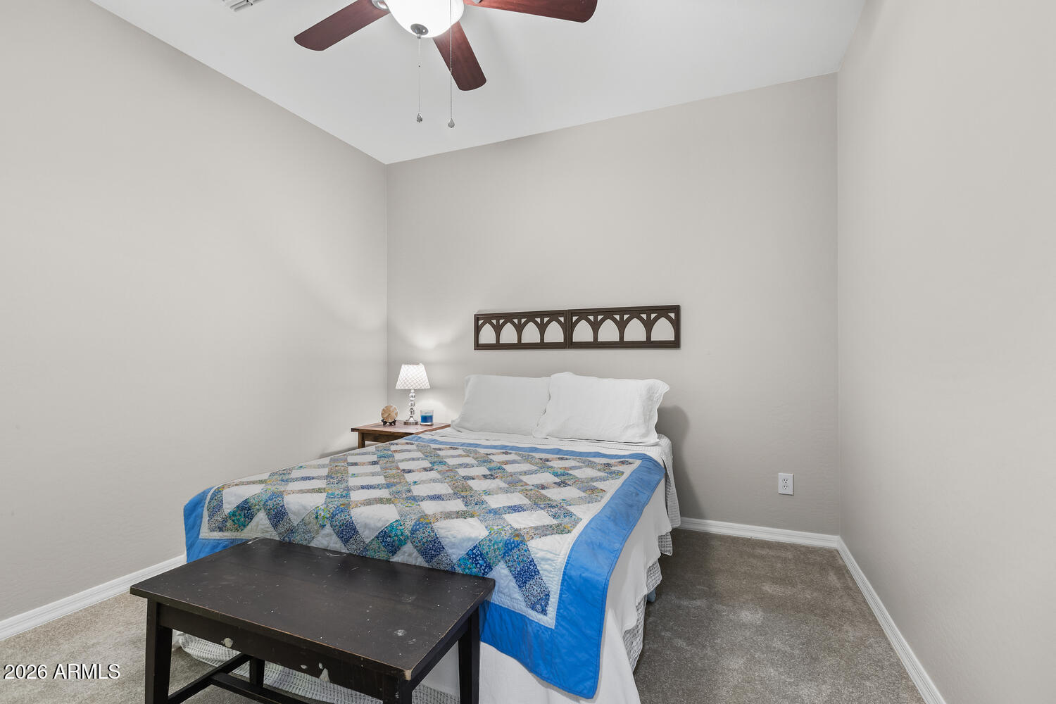 3246 North Springfield Street Buckeye, AZ 85396 - Photo 15 of 27 a bedroom with a table chairs and a bed