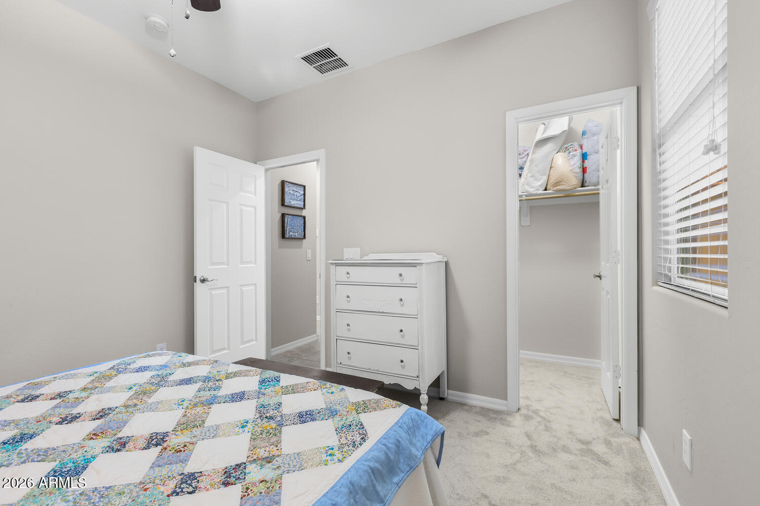 3246 North Springfield Street Buckeye, AZ 85396 - Photo 16 of 27 a bedroom with a bed and a cabinets