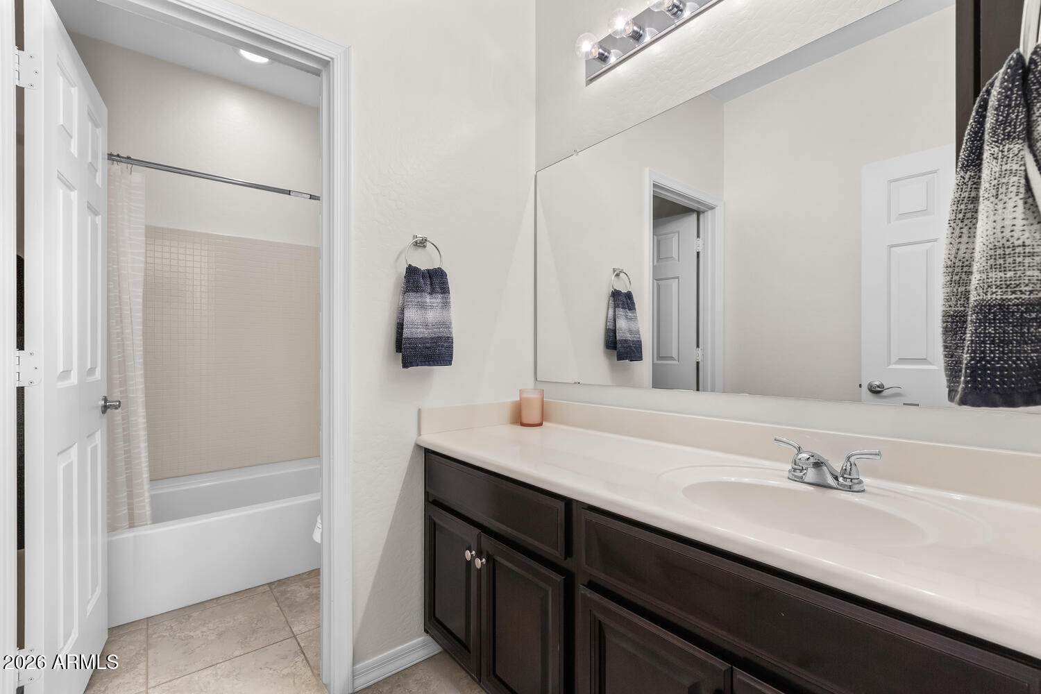3246 North Springfield Street Buckeye, AZ 85396 - Photo 17 of 27 a bathroom with a sink double vanity granite tub shower and a mirror