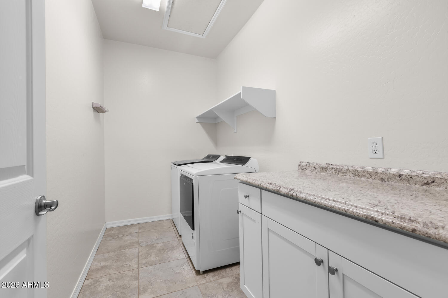 3246 North Springfield Street Buckeye, AZ 85396 - Photo 20 of 27 a utility room with a sink washer and dryer