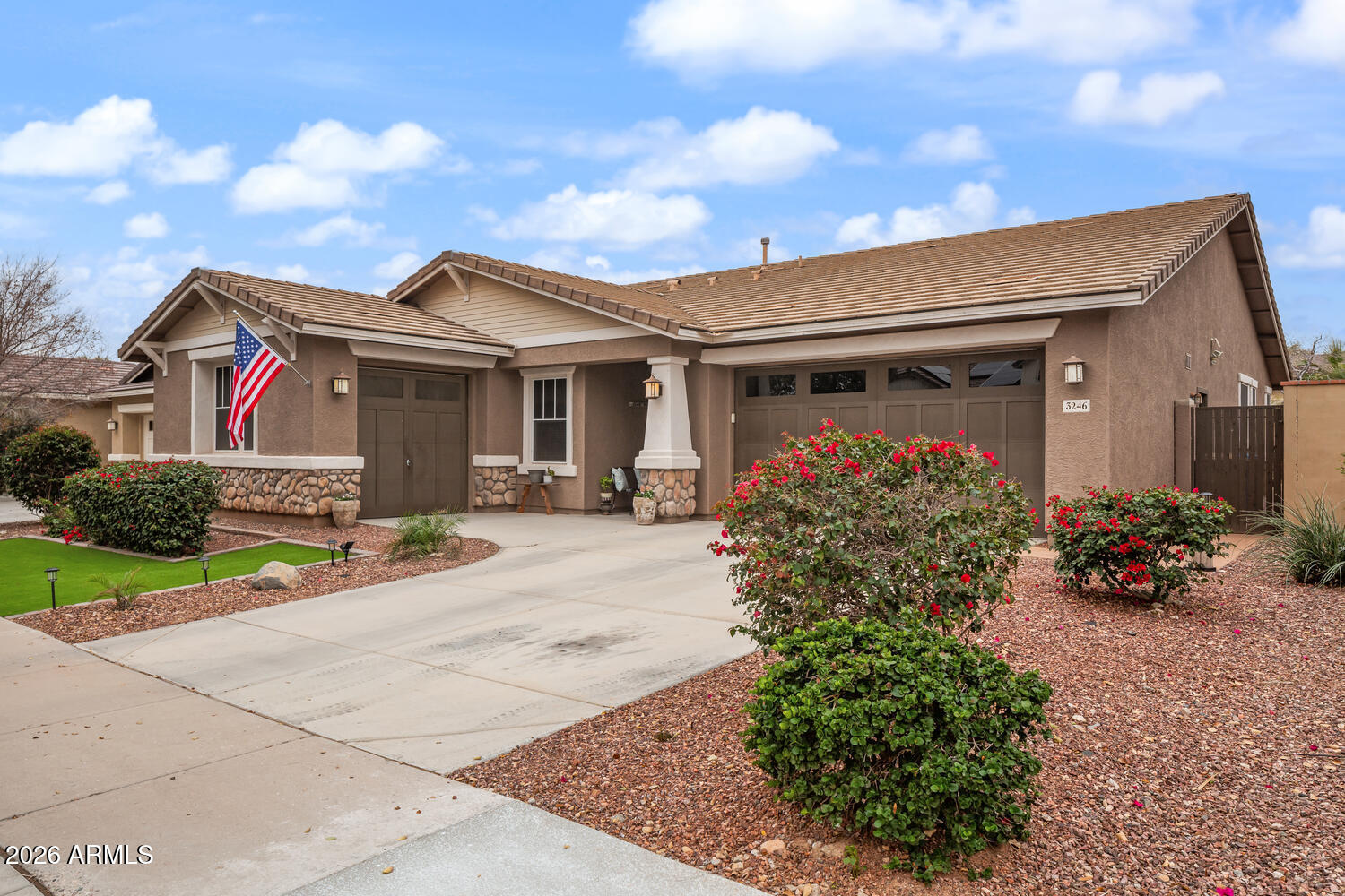 3246 North Springfield Street Buckeye, AZ 85396 - Photo 2 of 27 a front view of a house with a porch and a garage
