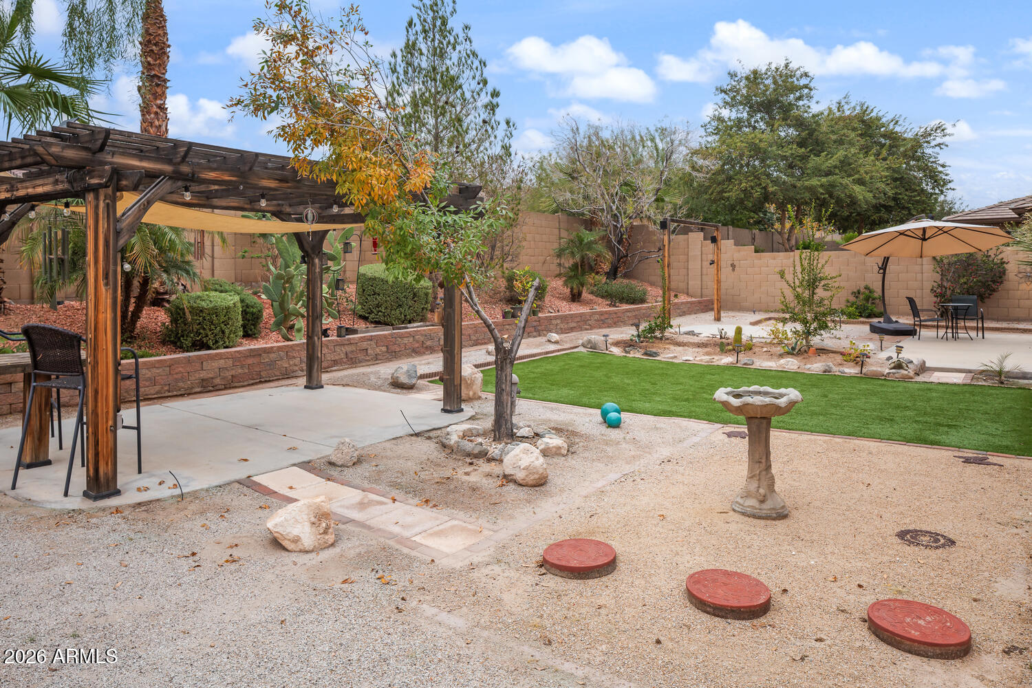 3246 North Springfield Street Buckeye, AZ 85396 - Photo 23 of 27 a view of a backyard with table and chairs