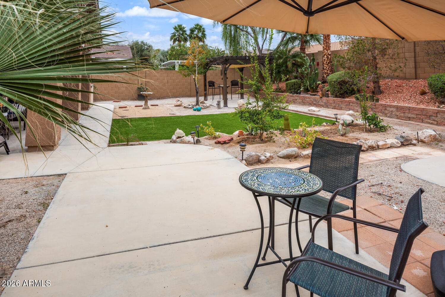 3246 North Springfield Street Buckeye, AZ 85396 - Photo 24 of 27 a view of a chairs and table in backyard